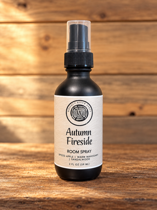 Autumn Fireside 2 fl oz room spray by Whiskey River Angel, matte-black bottle on rustic wood